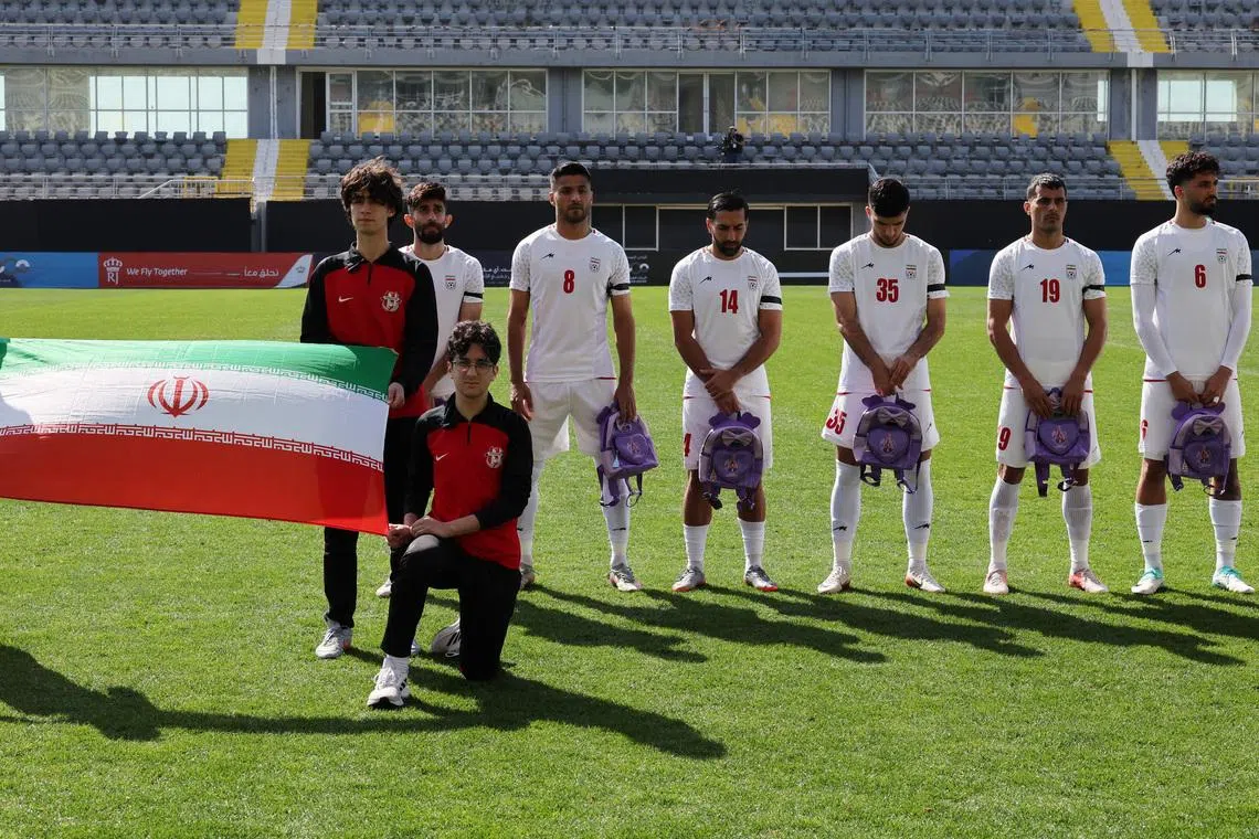 Iranian players hold schoolbags in solidarity with slain girls