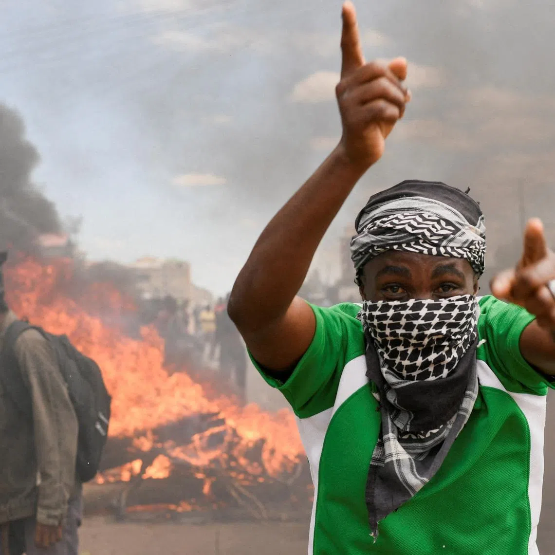 A demonstrator gestures as they erect a barricade during a protest against a U.S.-backed Ebola quarantine plan on the establishment of a 50-bed facility at a Kenyan air force base that was intended to host Americans exposed to Ebola, in Nanyuki town, in Laikipia County, Kenya June 1, 2026. REUTERS/John Muchucha