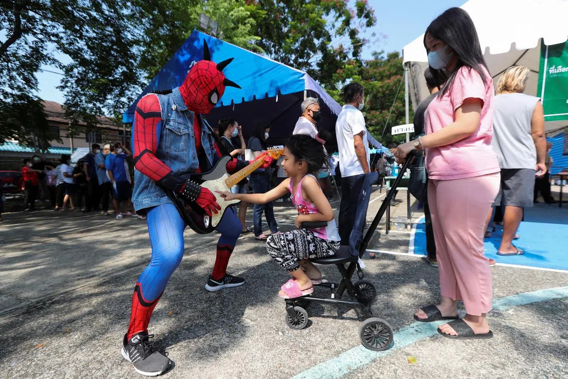 A person dressed as Spider-Man interacts with a child while encouraging voters to vote in the general election at a polling station in Bangkok, Thailand, May 14, 2023. REUTERS/Stringer