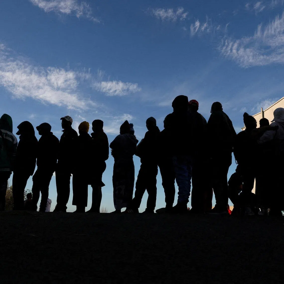 FILE PHOTO: Zimbabwean migrants queue outside the Zimbabwe Consulate amid fears of anti-immigrant violence ahead of a June 30 deadline set by activists demanding undocumented migrants leave the country, in Cape Town, South Africa, June 24, 2026. REUTERS/Esa Alexander/File Photo