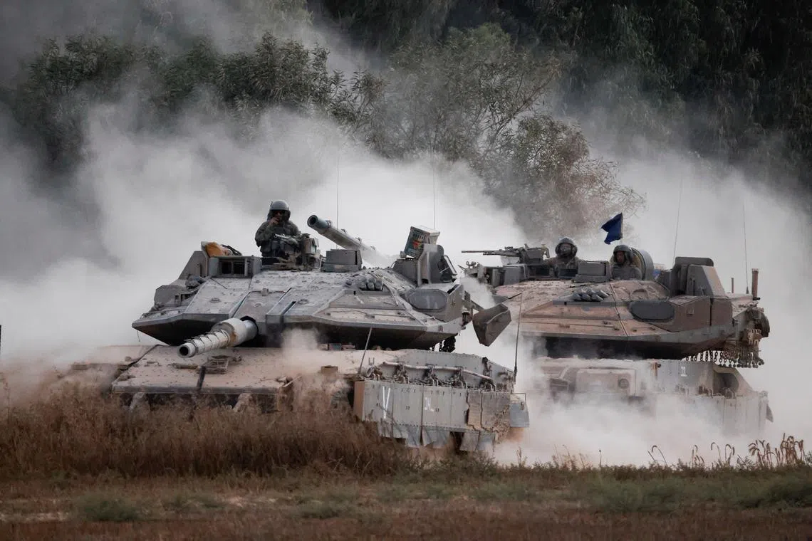 Israeli tanks manoeuvre near the border after entering Israel from Gaza, amid the Israel-Hamas conflict, as seen from Israel, July 4, 2024. REUTERS/Amir Cohen/File Photo