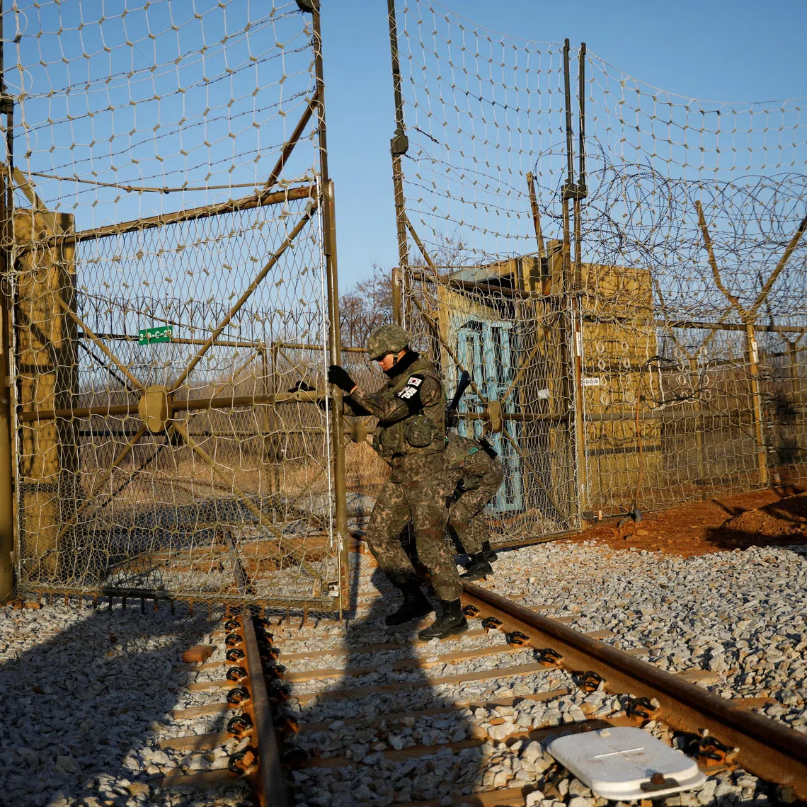 South Korean soldiers open the gate as the rails which leads to North Korea is seen, inside the demilitarized zone separating the two Koreas in Paju.