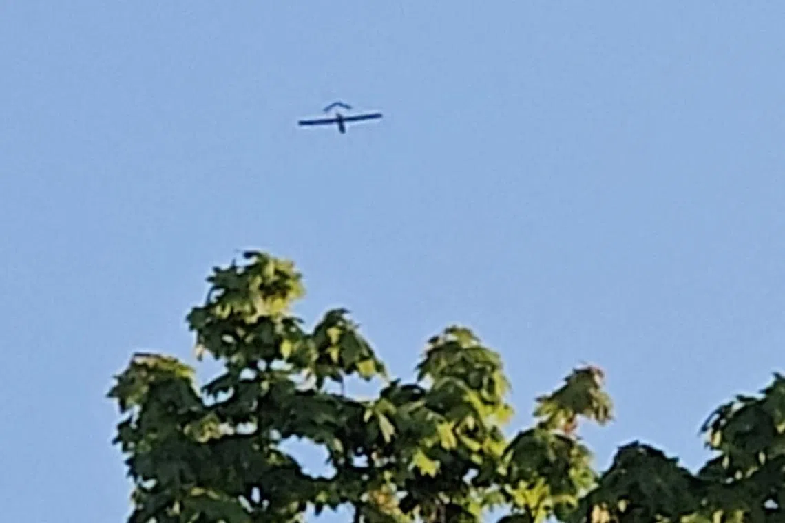 An aircraft flying over a village in Latvia's Ludza district, after the Latvian military said a drone had entered the country's airspace, on May 17. Latvia said on May 21 it had detected at least one drone flying in the country’s airspace.