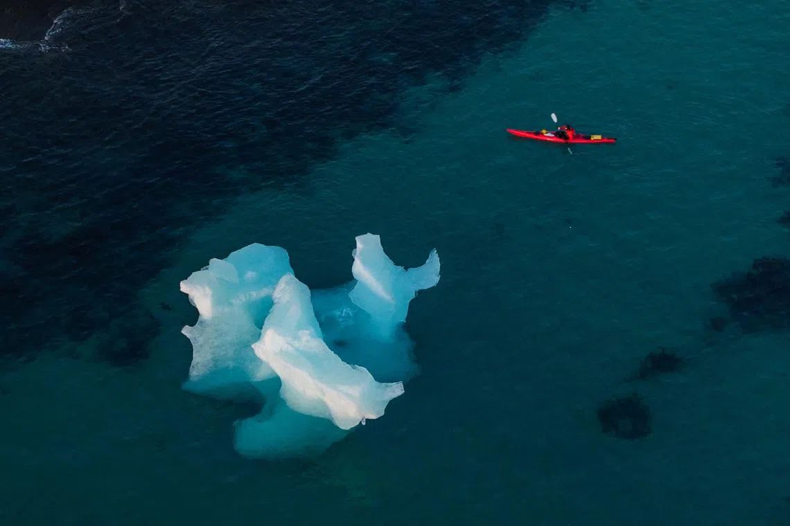 A man kayaking next to an iceberg in Nuuk, Greenland, on Jan 25, 2026. 