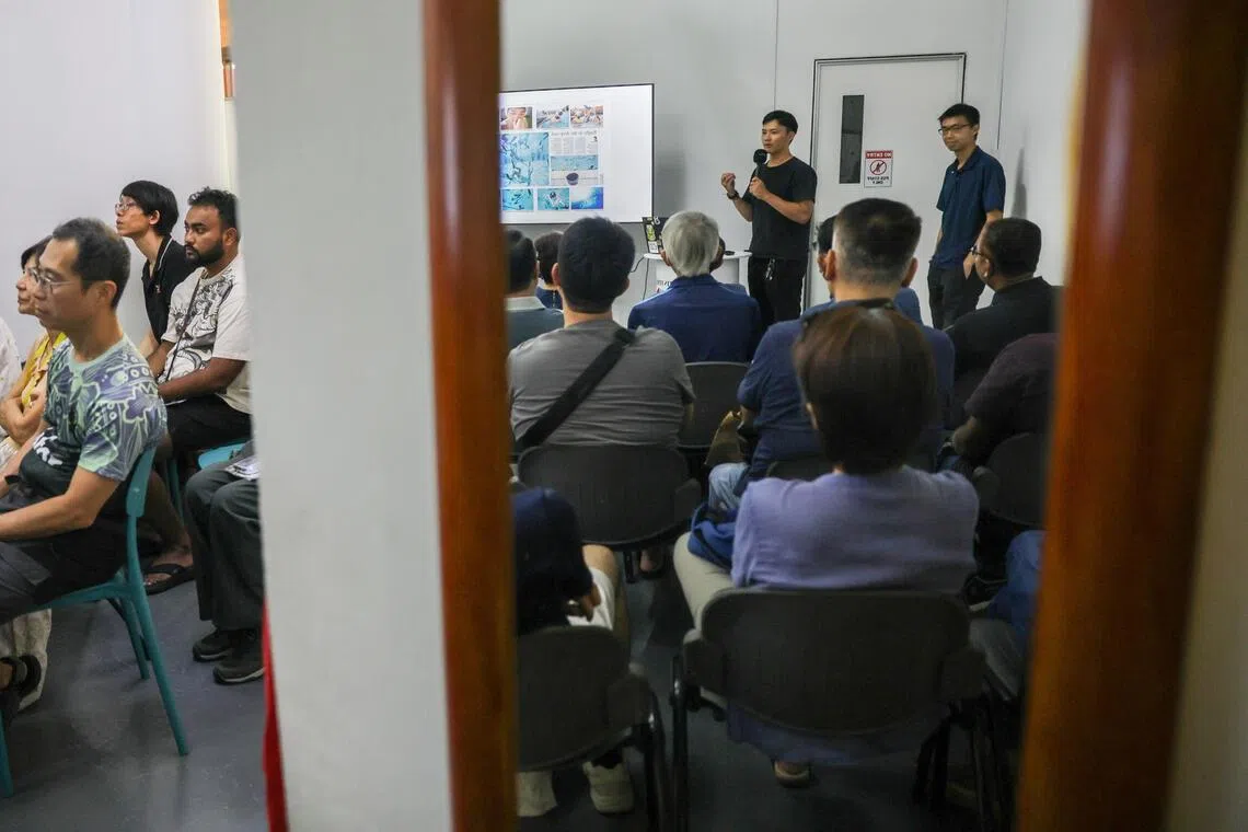 The Straits Times photojournalists Mark Cheong (standing, left) and Brian Teo during their talk, Finding Singapore Stories, at the ST180 Photo Exhibition on Nov 15.