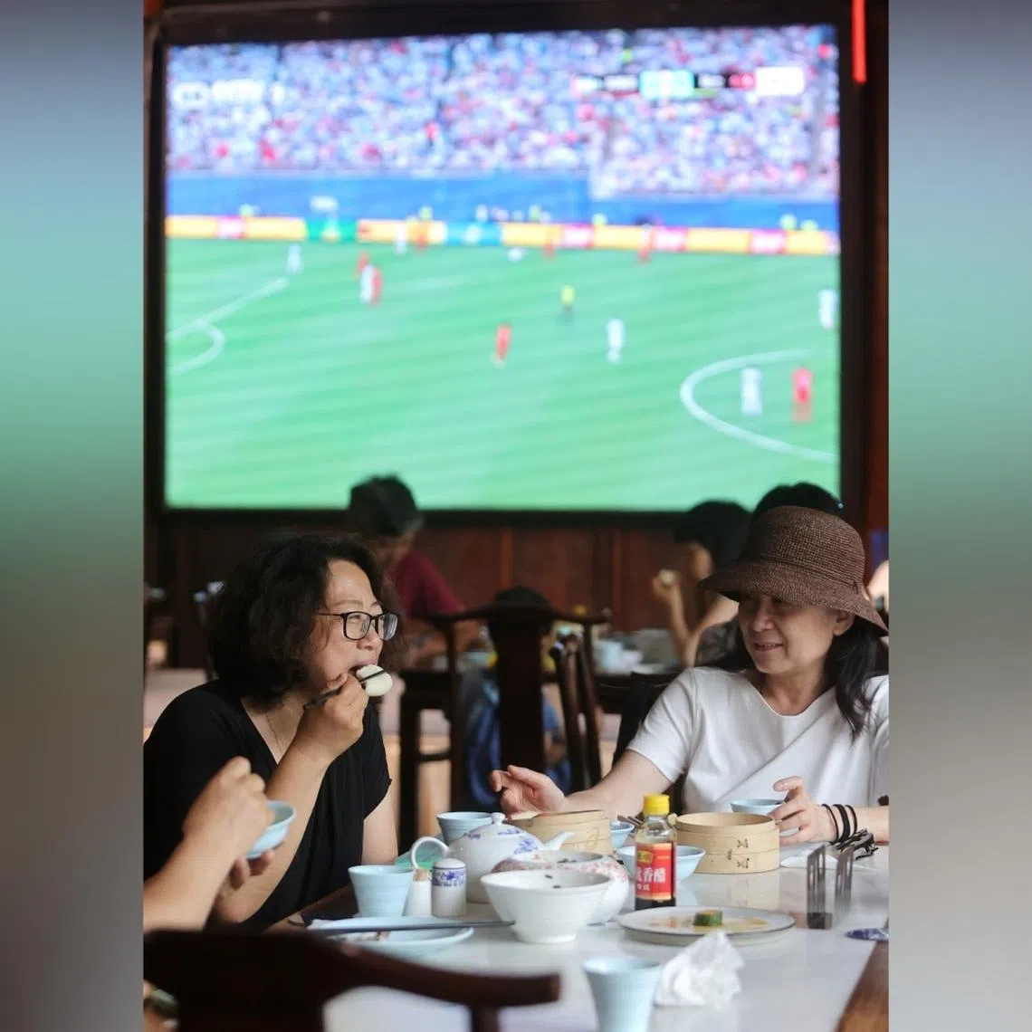 Customers enjoy morning tea in front of a World Cup live stream at a teahouse in Yangzhou, Jiangsu province.