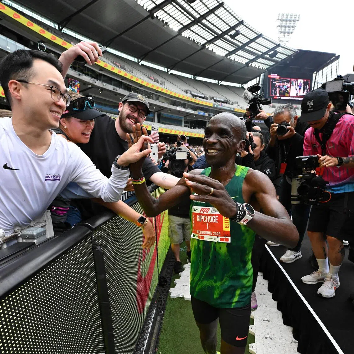 Eliud Kipchoge of Kenya celebrates with the spectators after crossing the finish line to win the 2026 Melbourne Marathon on Oct 11.