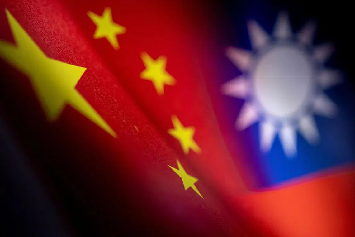 FILE PHOTO: Chinese and Taiwanese printed flags are seen in this illustration taken, April 28, 2022. Picture taken April 28, 2022.  REUTERS/Dado Ruvic/Illustration/File Photo
