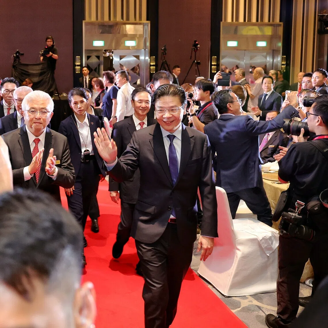 PM Lawrence Wong, accompanied by Singapore Federation of Chinese Clan Associations (SFCCA) president Thomas Chua, arriving at SFCCA’s 40th anniversary gala dinner on Oct 13.