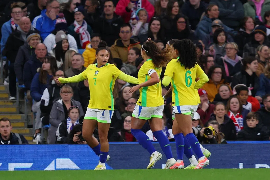 Brazil's Dudinha celebrating with teammates after scoring their second goal in the 2-1 win over England at the Etihad Stadium on Oct 25. 