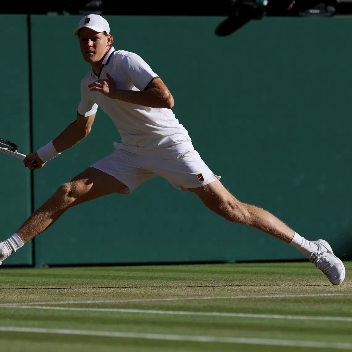 Jul 12, 2026; London, United Kingdom; Jannik Sinner (ITA) reaches for a forehand against Alexander Zverev (GER) (not pictured) in the gentlemen's singles final of The Championships Wimbledon 2026 at All England Lawn Tennis and Croquet Club. Mandatory Credit: Geoff Burke-Imagn Images