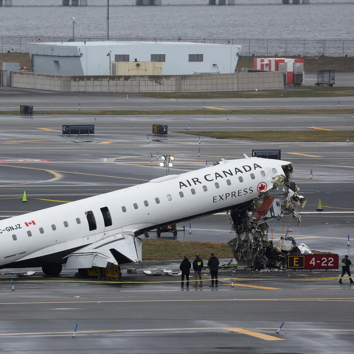 Personnel of the National Transportation Safety Board (NTSB) inspect the wreckage of an Air Canada Express jet that collided with a ground vehicle at New York's LaGuardia Airport in Queens, New York, U.S., March 23, 2026.  REUTERS/Shannon Stapleton