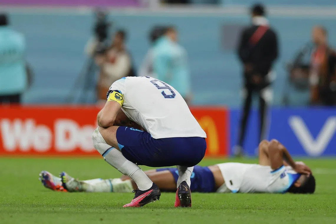 epa10360426 Harry Kane (front) of England reacts after losing the FIFA World Cup 2022 quarter final soccer match between England and France at Al Bayt Stadium in Al Khor, Qatar, 10 December 2022.  EPA-EFE/Ronald Wittek