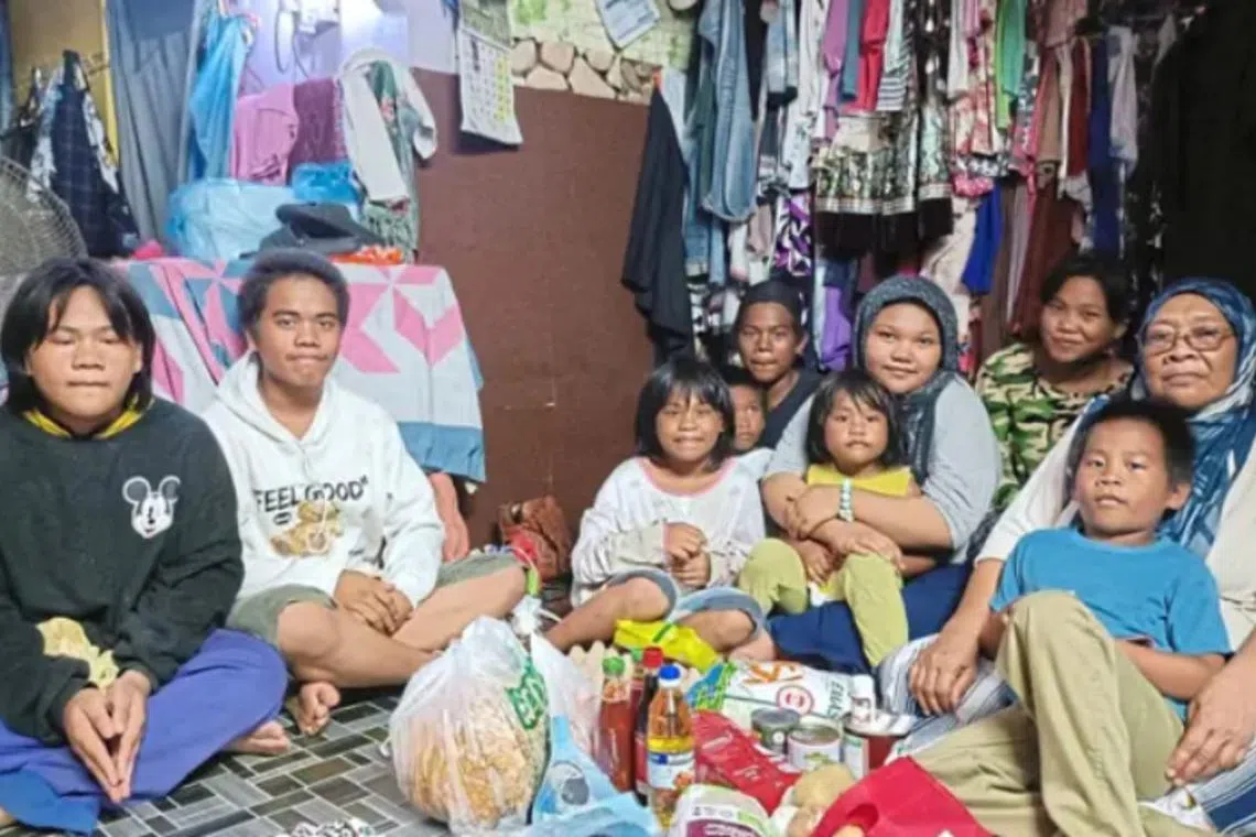 Ms Dayang (right) has been caring for nine grandchildren single-handedly over the past year after her son was jailed for a drug offence.