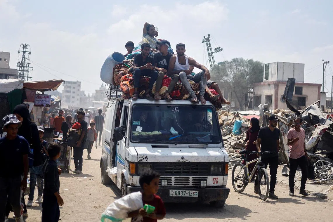 Palestinians, who fled the eastern part of Khan Younis after they were ordered by Israeli army to evacuate their neighborhoods, ride on a vehicle loaded with belongings, amid Israel-Hamas conflict, in Khan Younis in the southern Gaza Strip July 2, 2024. REUTERS/Mohammed Salem