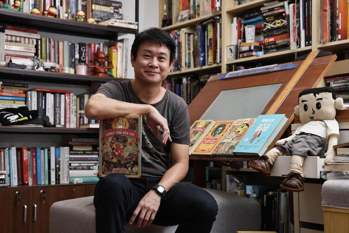 Illustrator Sonny Liew at his studio, with various editions of his acclaimed 2015 graphic novel, The Art Of Charlie Chan Hock Chye. 