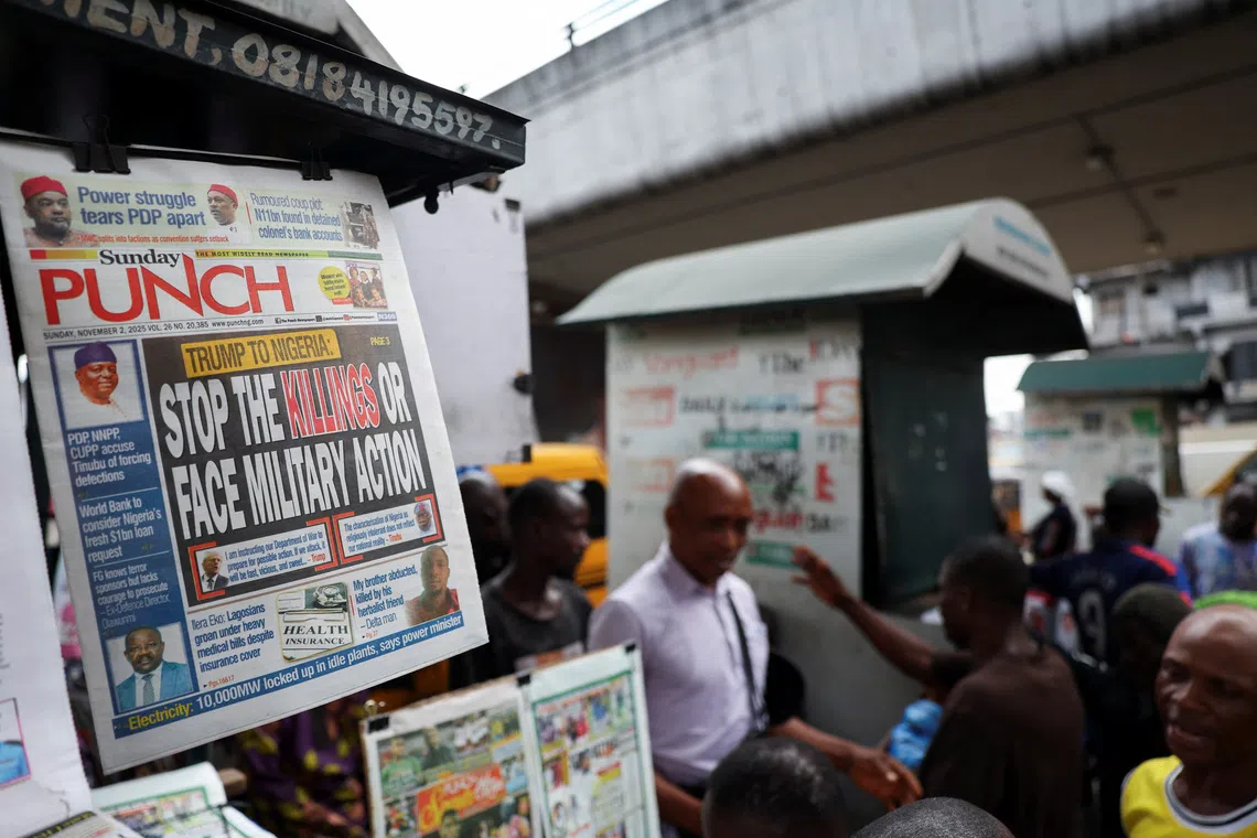 A newspaper with an article reporting U.S. President Donald Trump's message to Nigeria over the treatment of Christians hangs at a newspaper stand in Ojuelegba, Lagos, Nigeria. November 2, 2025. REUTERS/Sodiq Adelakun