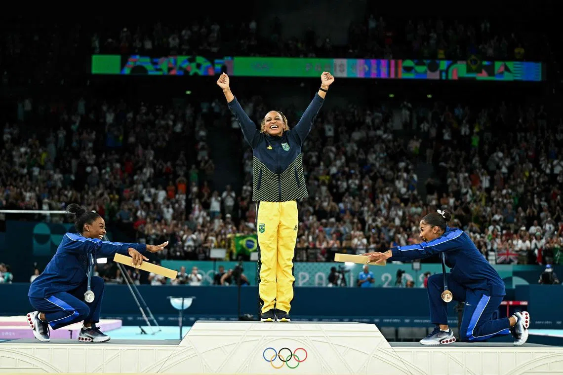 From left: The United States' Simone Biles (silver), Brazil's Rebeca Andrade (gold) and US' Jordan Chiles (bronze) posing during the podium ceremony for the artistic gymnastics women's floor exercise event of the Paris 2024 Olympic Games at the Bercy Arena on Aug 5. Romanian Ana Barbosu was later awarded the bronze medal after the Court of Arbitration for Sport ruled that Chiles should not have been upgraded from her initial fifth-place finish.