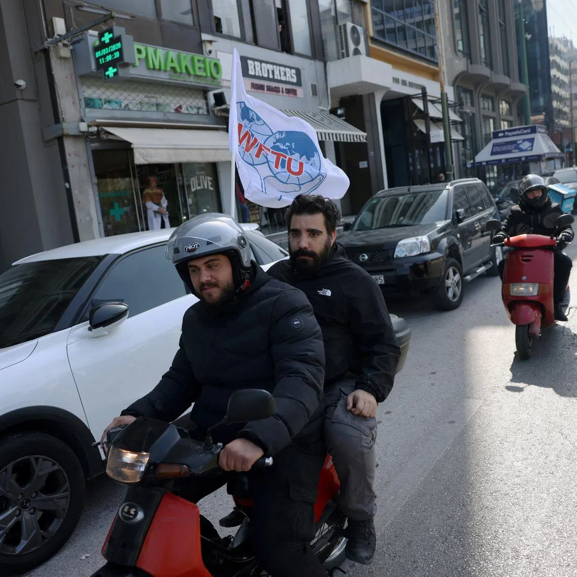 Greek seafarers participate at a motorcycle protest, as they move towards the Ministry of Maritime Affairs and Insular Policy to demand the return of crews stranded aboard commercial vessels in the Strait of Hormuz following the widening Iran conflict, in Piraeus, Greece, March 5, 2026. REUTERS/Louiza Vradi