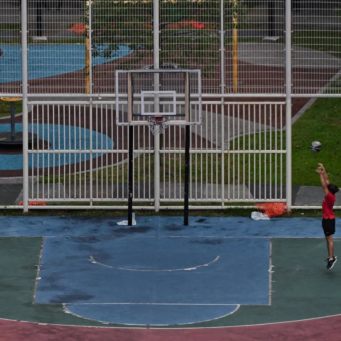 ST20211102_202112064811 Kua Chee Siong/ pixgeneric/ Generic pix of a boy playing basketball alone in a basketball court in Ang Mo Kio Avenue 10 on 2 Nov 2021.