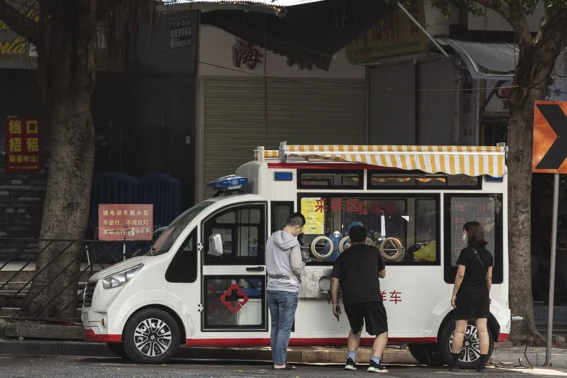 Residents queue at a Covid-19 testing truck in Guangzhou, China.