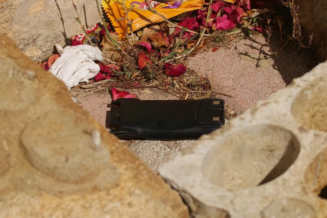 A communication device on the ground as Lebanese army forces prepare to destroy it in a controlled explosion, in southern Lebanon, on Sept 19.