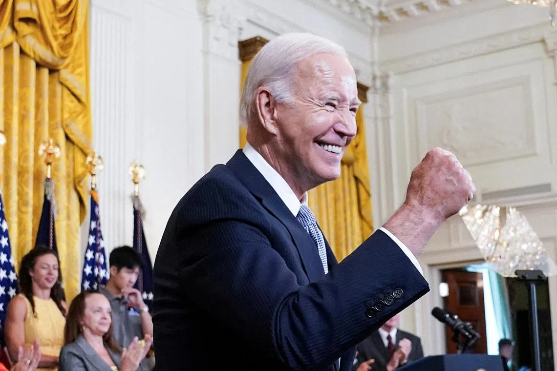 FILE PHOTO: U.S. President Joe Biden gives a fist bump salute to the audience during an event to celebrate the anniversary of his signing of the 2022 Inflation Reduction Act legislation, in the East Room of the White House in Washington, U.S., August 16, 2023. REUTERS/Kevin Lamarque/File Photo