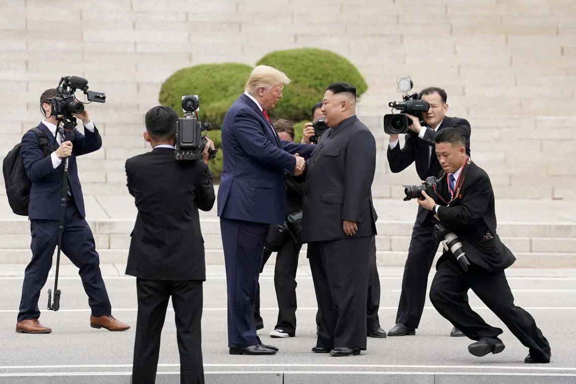 FILE PHOTO: U.S. President Donald Trump meets with North Korean leader Kim Jong Un at the demilitarized zone separating the two Koreas, in Panmunjom, South Korea, June 30, 2019. REUTERS/Kevin Lamarque/File Photo