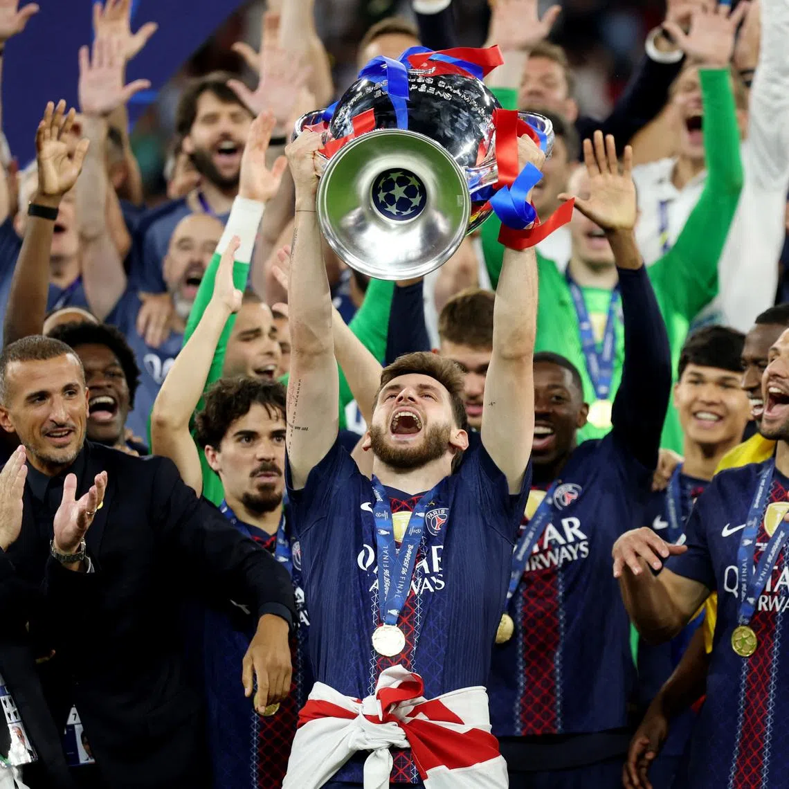 Soccer Football - UEFA Champions League - Final - Paris St Germain v Arsenal - Puskas Arena, Budapest, Hungary - May 30, 2026 Paris St Germain's Khvicha Kvaratskhelia with the trophy as he celebrates with players and staff after winning the UEFA Champions League REUTERS/Phil Noble