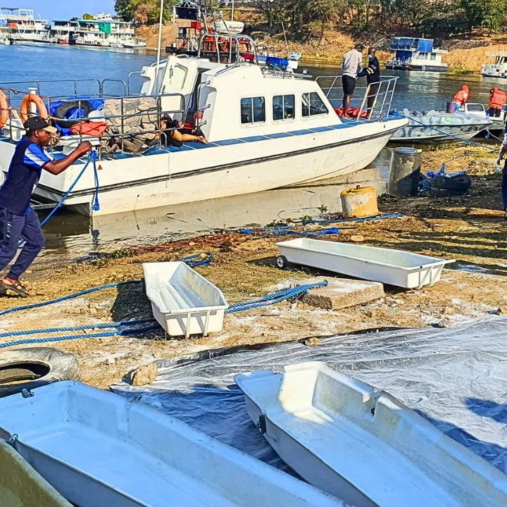SENSITIVE MATERIAL. THIS IMAGE MAY OFFEND OR DISTURB Rescue and recovery personnel work along the shoreline of Lake Kariba during an operation to recover victims from a Rural Infrastructure Development Agency (RIDA) passenger ferry that capsized near Kariba, Zimbabwe, August 17, 2026.  REUTERS/Bright Charakupa
