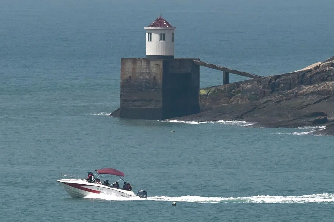 A tour boat sails past a guard post on Pingtan island, the closest point in China to Taiwan.
