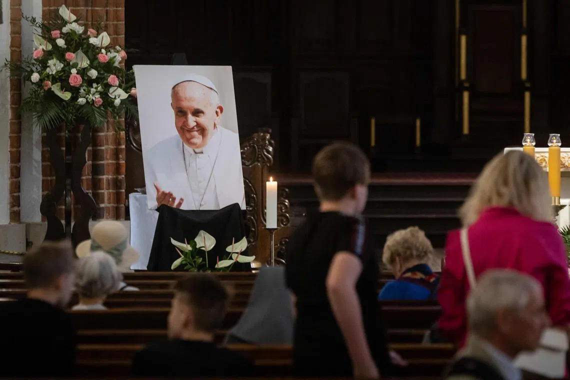 A photo of Pope Francis is displayed in the St John's Archcathedral in Warsaw's Old Town on April 21.