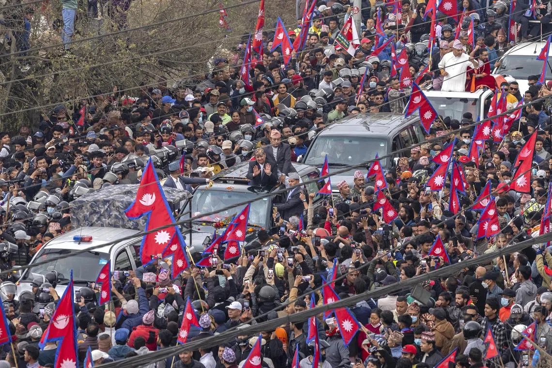 Nepal's former King Gyanendra Shah (centre) greets his supporters during a pro-monarchy rally in Kathmandu, Nepal.