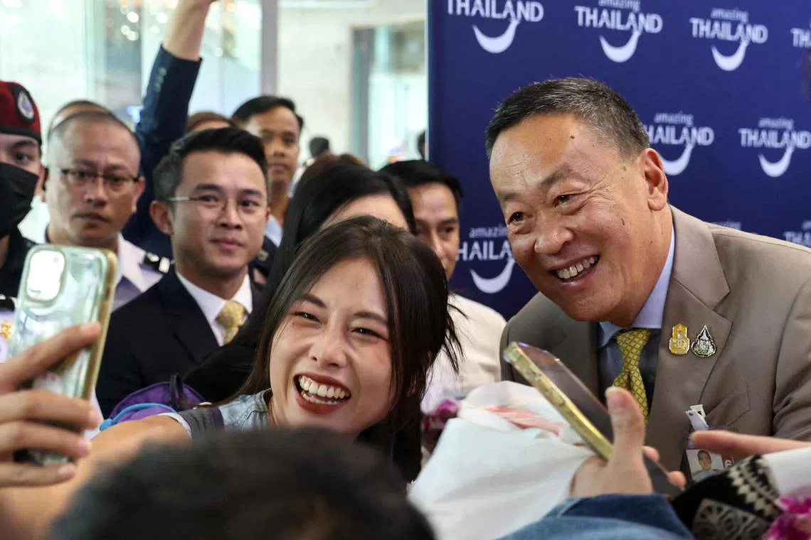 A Chinese tourist takes a selfie with Thailand's Prime Minister Srettha Thavisin during a welcome ceremony of the first batch of Chinese tourists under a five-month visa-free entry scheme at Bangkok’s International Airport in September 2023.