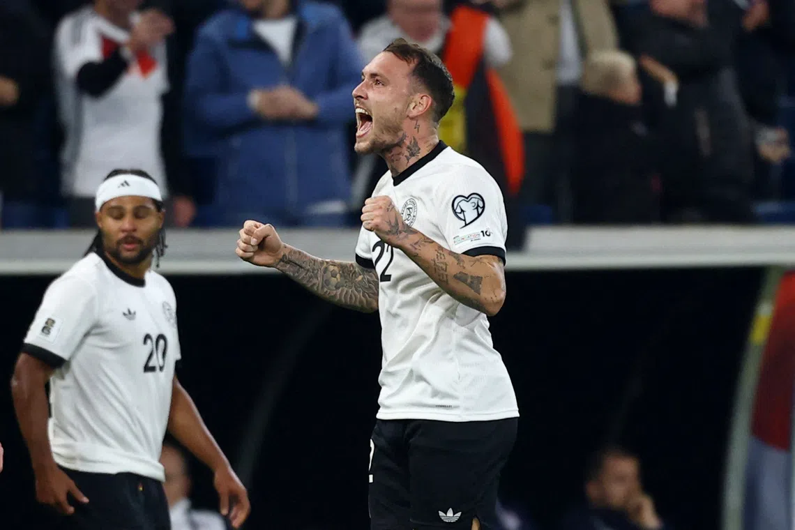 Soccer Football - FIFA World Cup - UEFA Qualifiers - Group A - Germany v Luxembourg - Rhein-Neckar-Arena, Sinsheim, Germany - October 10, 2025 Germany's David Raum celebrates scoring their first goal REUTERS/Kai Pfaffenbach