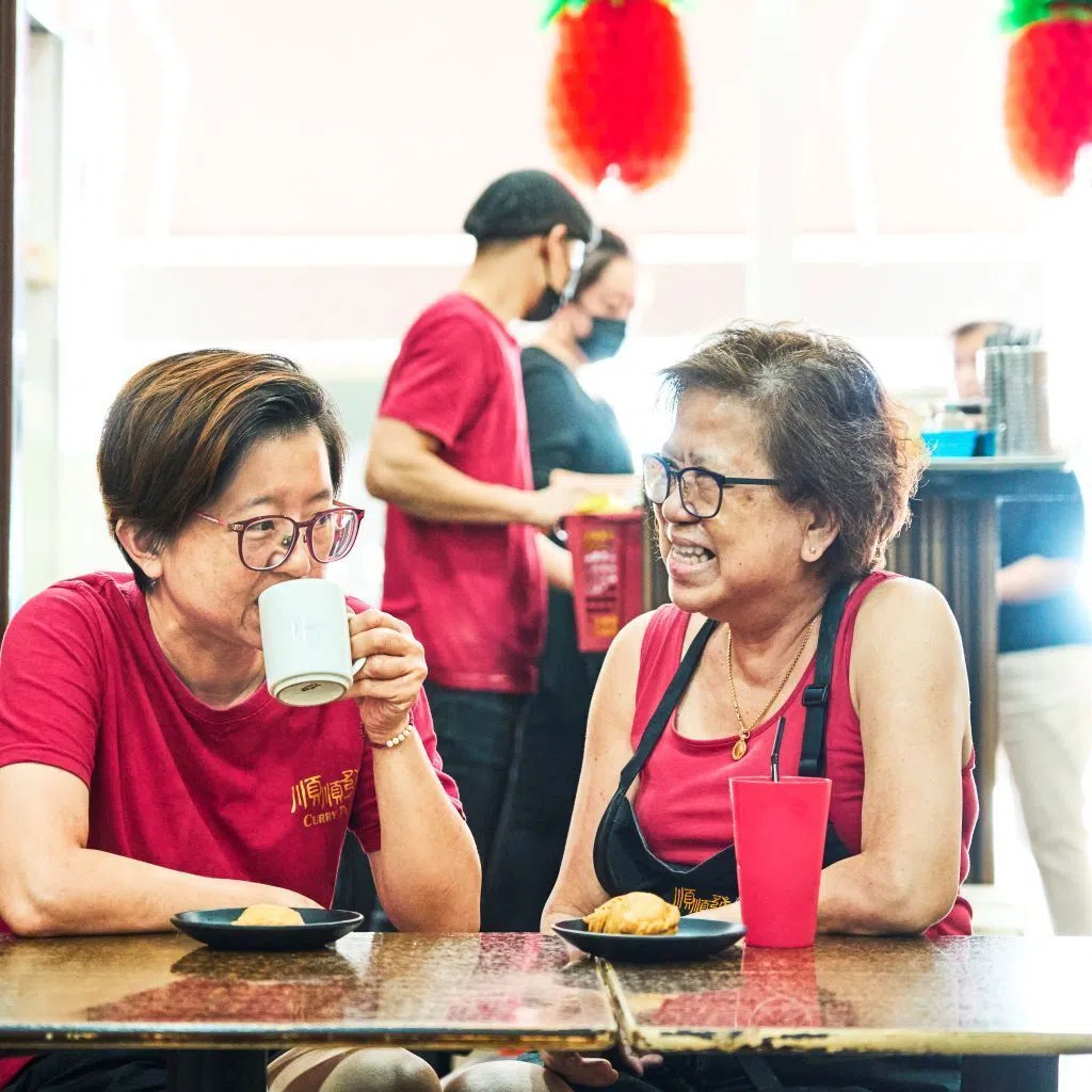 Ms Tay Mui Lan (left), who was diagnosed with a brain tumour five years ago, with her mother (right). Together, they run the family curry puff business along East Coast Road.
