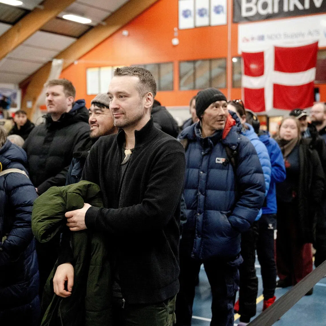 FILE PHOTO: Qarsoq Hoegh-Dam from Naleraq party stands in a queue to vote at a polling station in Nuuk at Godthaabhallen, Denmark March 24, 2026. Oscar Scott Carl/Ritzau Scanpix/via REUTERS/File Photo