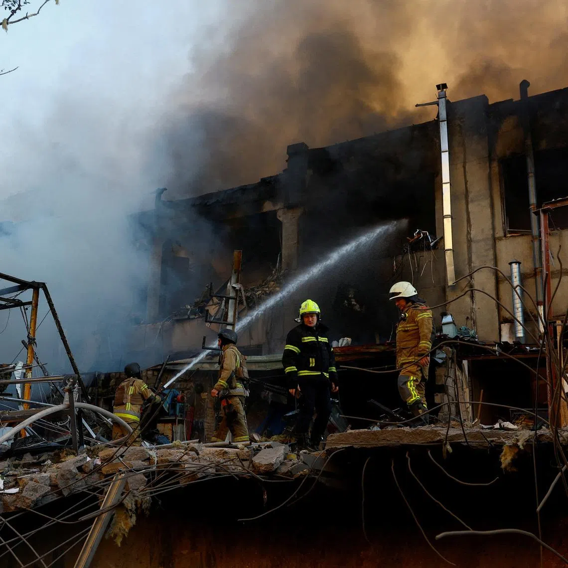 FILE PHOTO: Firefighters work at the site of a car repair workshop damaged during Russian missile and drone strikes, amid Russia's attack on Ukraine, in Kyiv, Ukraine June 2, 2026. REUTERS/Valentyn Ogirenko/File Photo