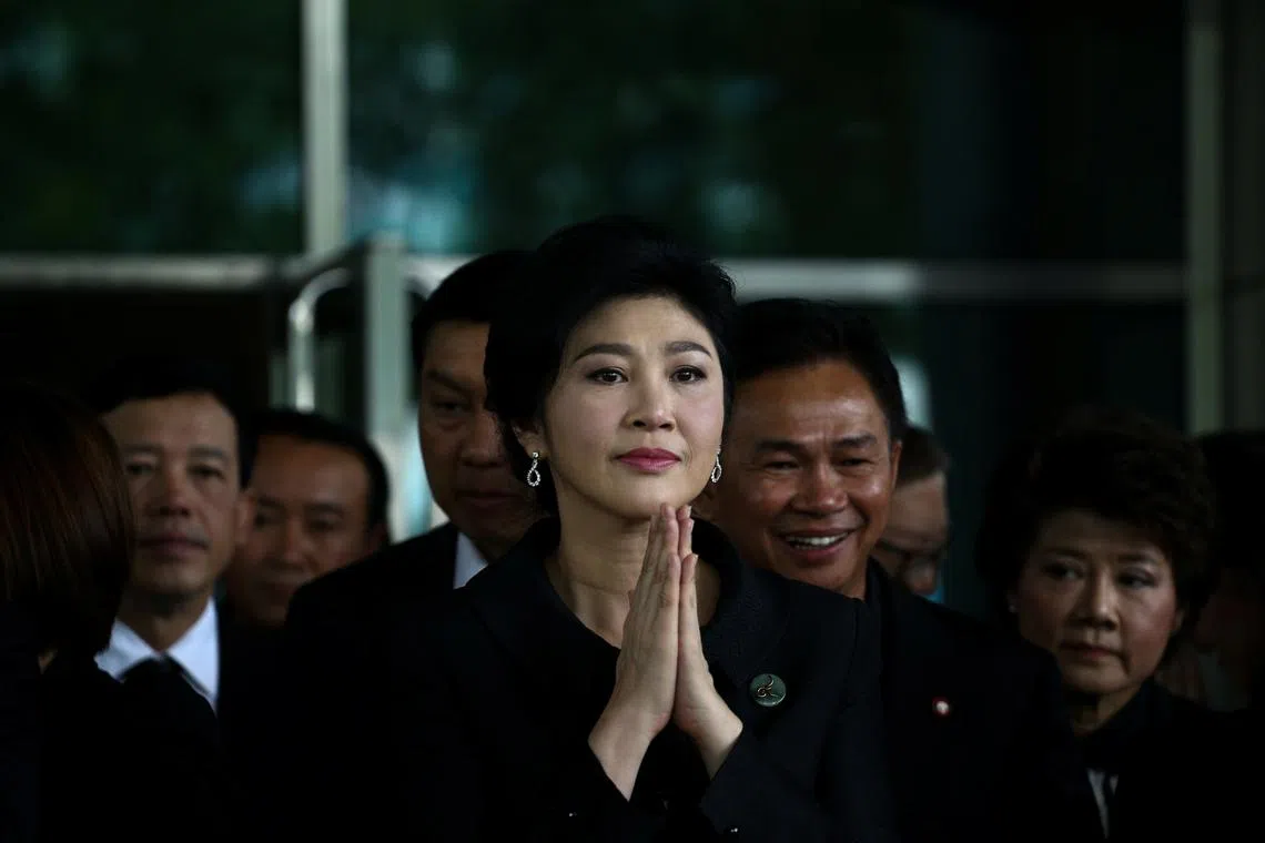 Ousted former Thai prime minister Yingluck Shinawatra greets supporters as she arrives at the Supreme Court in Bangkok, Thailand, July 21, 2017. REUTERS/Athit Perawongmetha/File Photo
