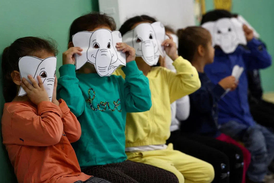 Refugee children playing at the kindergarten in the first reception center for refugees in Giessen, Germany, Oct 11.