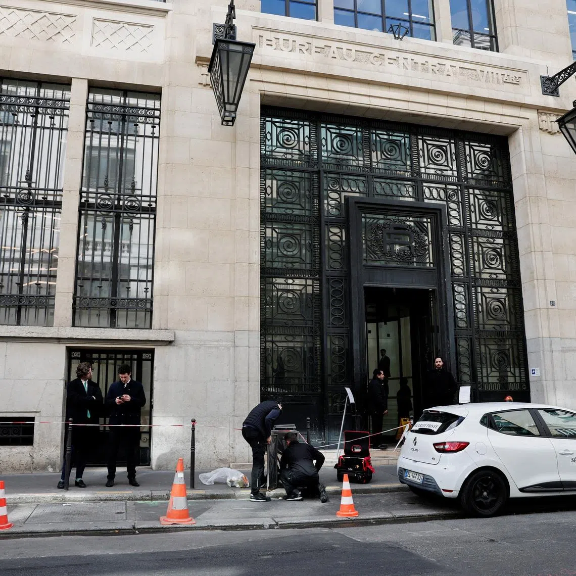 Private security members gather outside Bank of America’s Paris offices on March 30. 