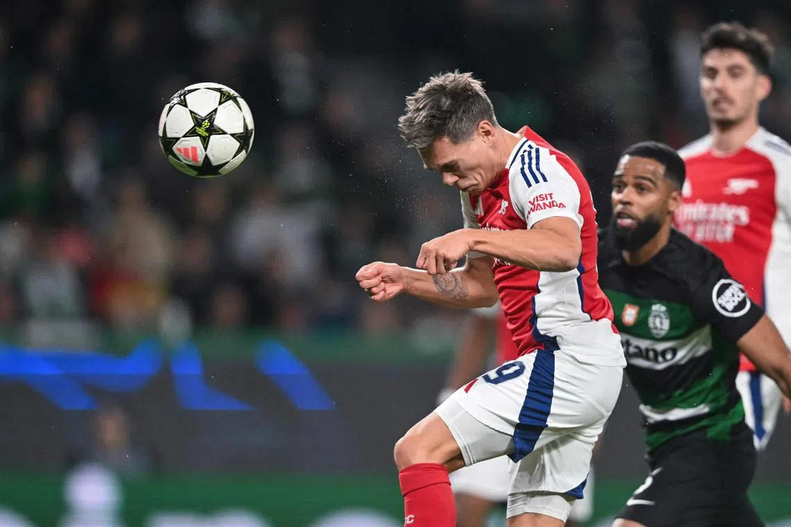 Midfielder Leandro Trossard heads in a goal during Arsenal's 5-1 rout of Sporting Lisbon.