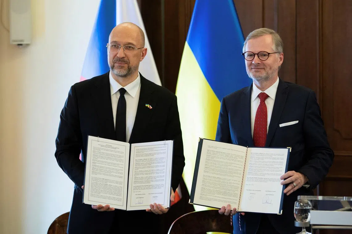 Czech Republic's Prime Minister Petr Fiala and Ukraine's Prime Minister Denys Shmyhal pose with a cooperation agreement before a press conference during a meeting in support of Ukraine with Czech government ministers leaders and government representatives in Prague, Czech Republic, July 16, 2024. REUTERS/Eva Korinkova