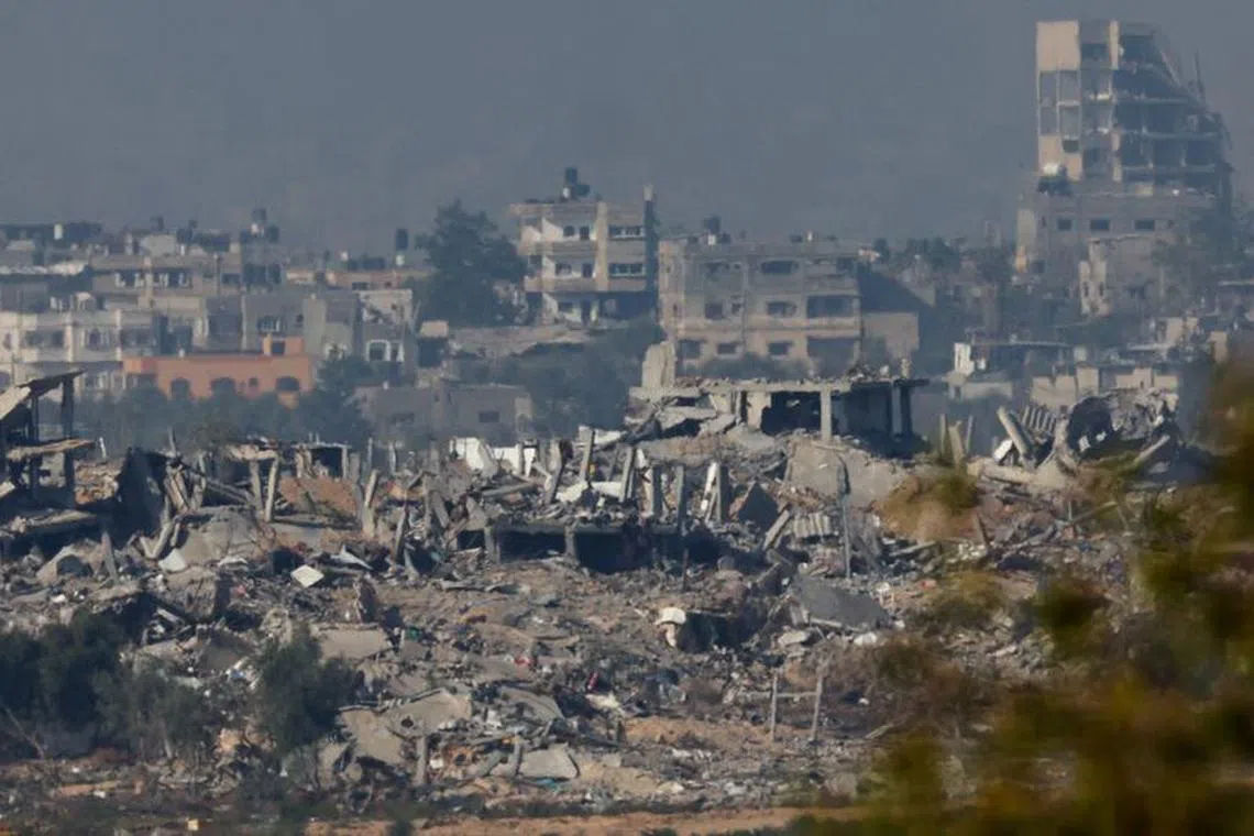 Buildings lie in ruin in Gaza, amid the ongoing conflict between Israel and the Palestinian Islamist group Hamas, as seen from southern Israel, December 4, 2023. REUTERS/Athit Perawongmetha