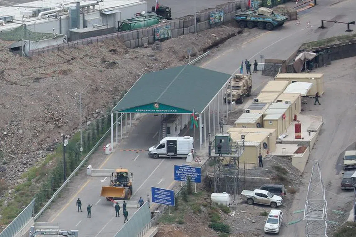 A view shows a border-crossing point on the frontier between Armenia and Azerbaijan and a base of Russian peacekeepers deployed in Nagorno-Karabakh as seen from a road near the village of Kornidzor, Armenia, September 23, 2023. REUTERS/Irakli Gedenidze