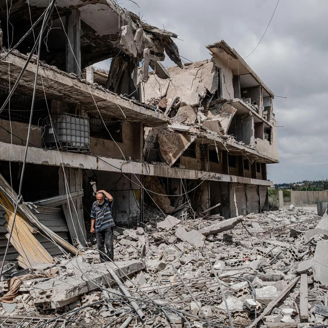 A resident assesses the damage in the aftermath of an Israeli airstrike in Tyre, Lebanon, on May 26.