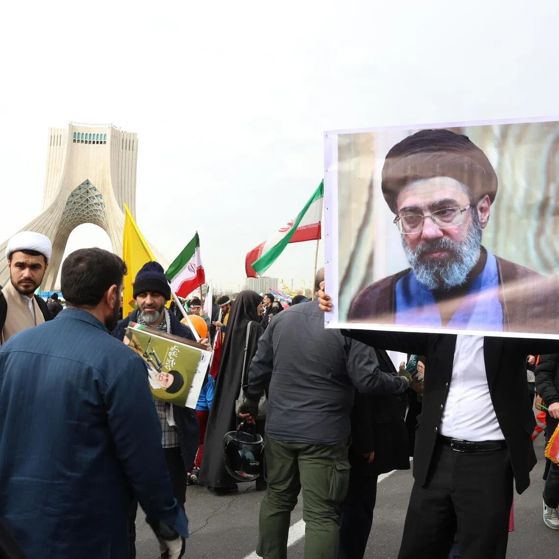 An Iranian holds a portrait of Iran’s new supreme leader, Ayatollah Mojtaba Khamenei.
