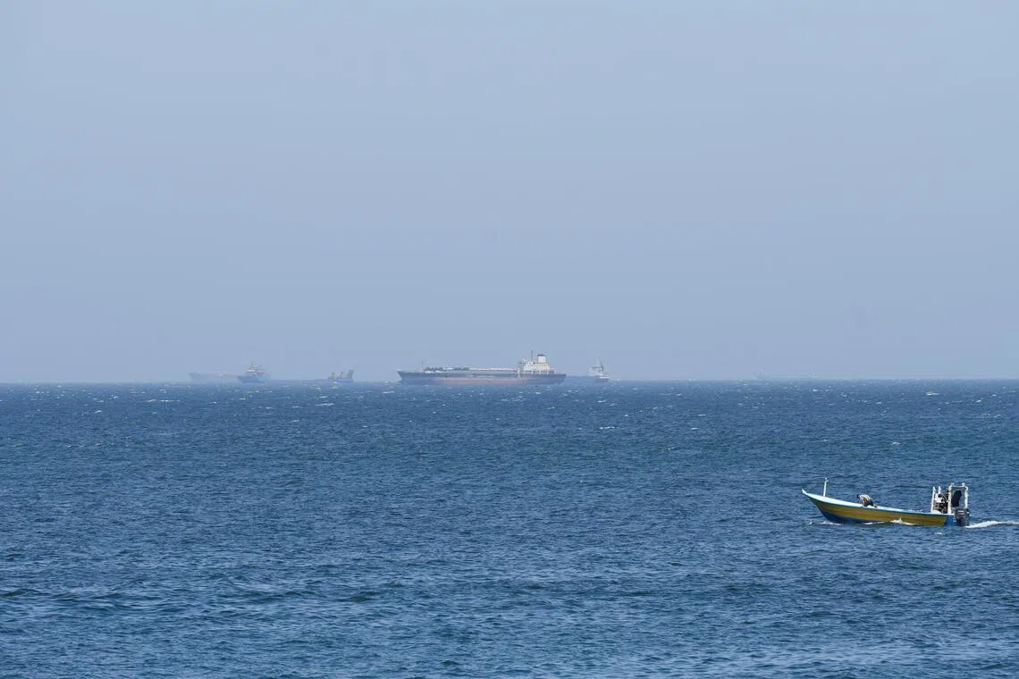 Vessels and boats are off the coast of Musandam governorate, overlooking the strait of Hormuz, in Oman on April 8, 2026.