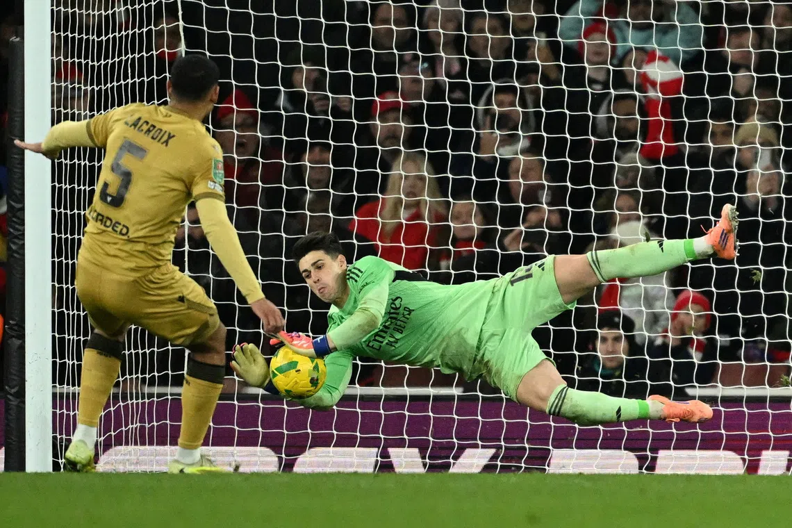 Soccer Football - Carabao Cup - Quarter Final - Arsenal v Crystal Palace - Emirates Stadium, London, Britain - December 23, 2025 Arsenal's Kepa Arrizabalaga saves a penalty from Crystal Palace's Maxence Lacroix during the penalty shootout REUTERS/Dylan Martinez
