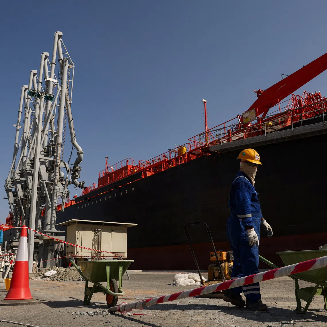 FILE PHOTO: A person works near an oil tanker docked at the Port of Fujairah, as the U.S.-Israel conflict with Iran limits marine traffic in the Strait of Hormuz, in Fujairah, United Arab Emirates, May 6, 2026. REUTERS/Amr Alfiky/ File Photo